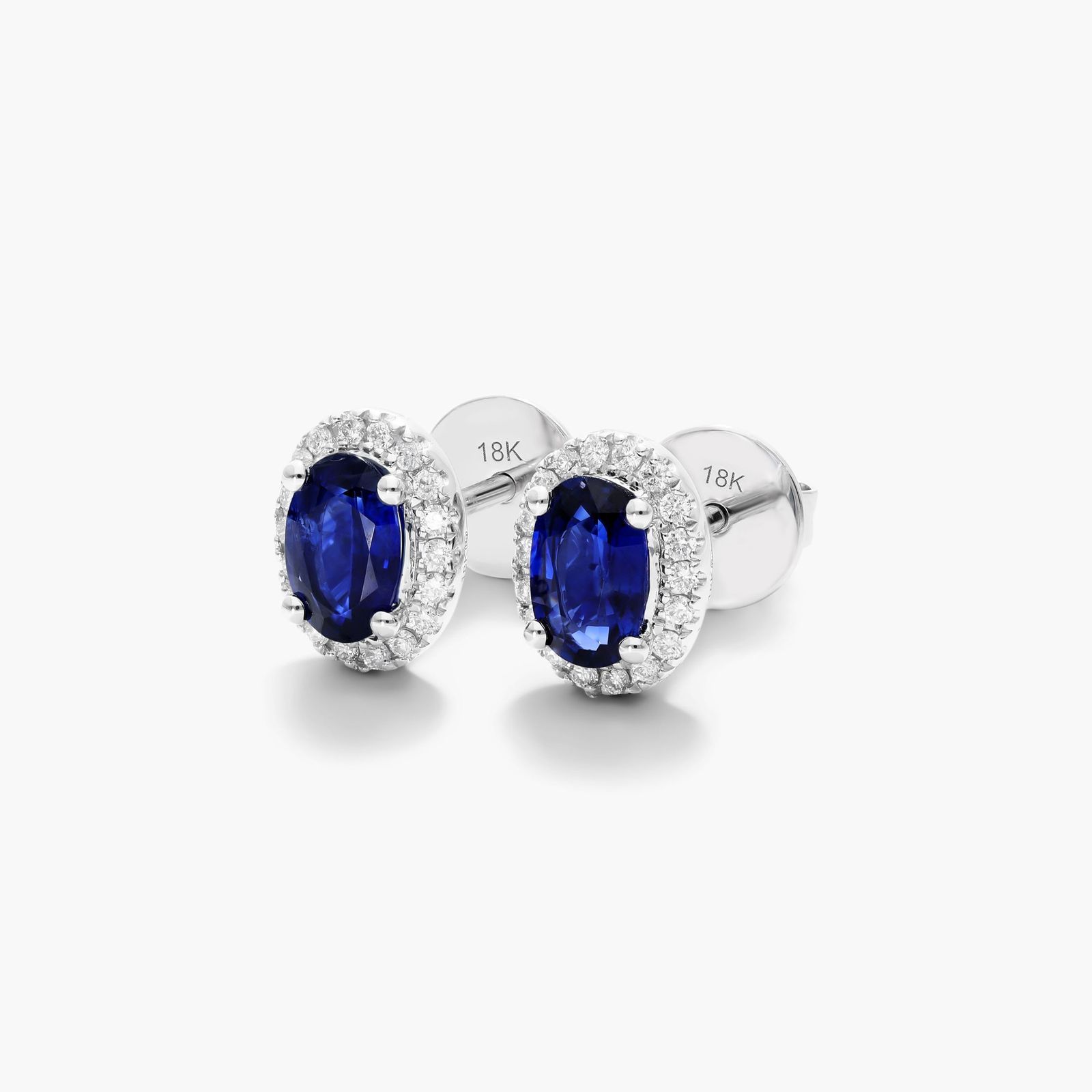 Oval Cut Sapphire And Diamond Halo Earrings In 18K White Gold