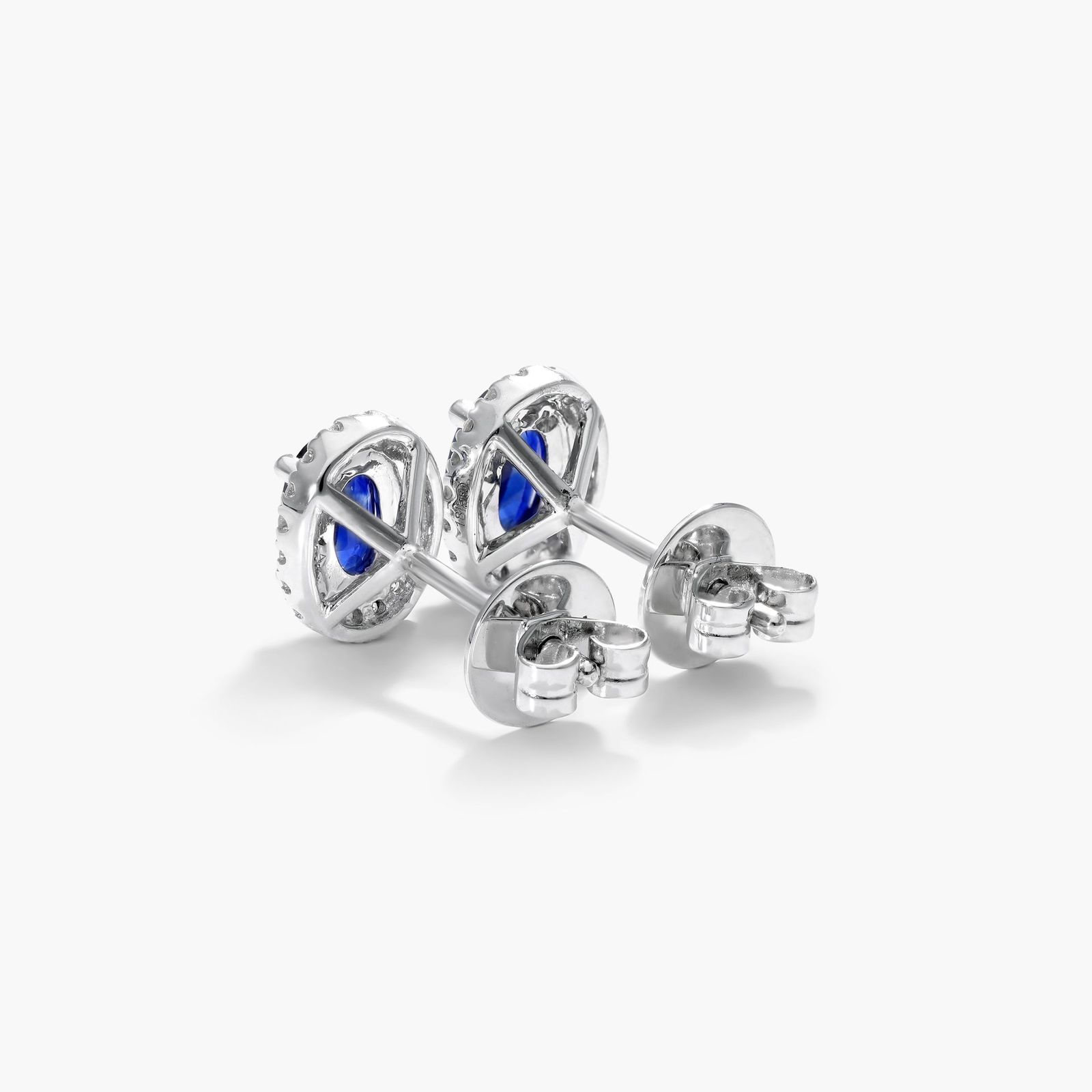 Oval Cut Sapphire And Diamond Halo Earrings In 18K White Gold