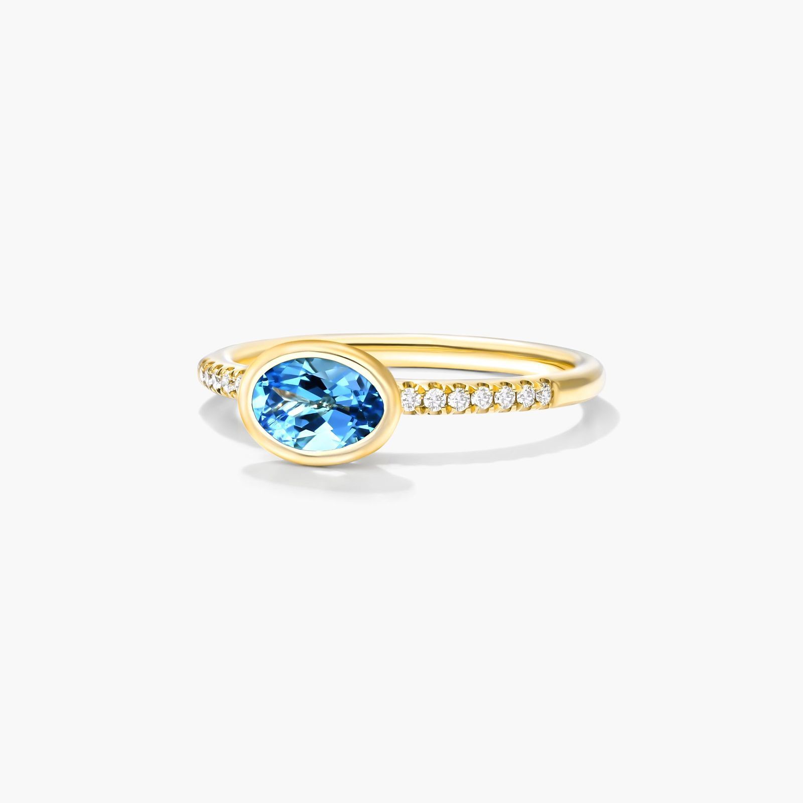 East-West Oval Blue Topaz And Diamond Ring In 18K Yellow Gold