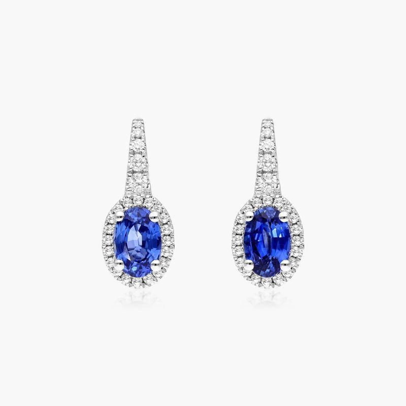 Petite Oval Cut Sapphire And Diamond Halo Drop Earrings In 18K White Gold