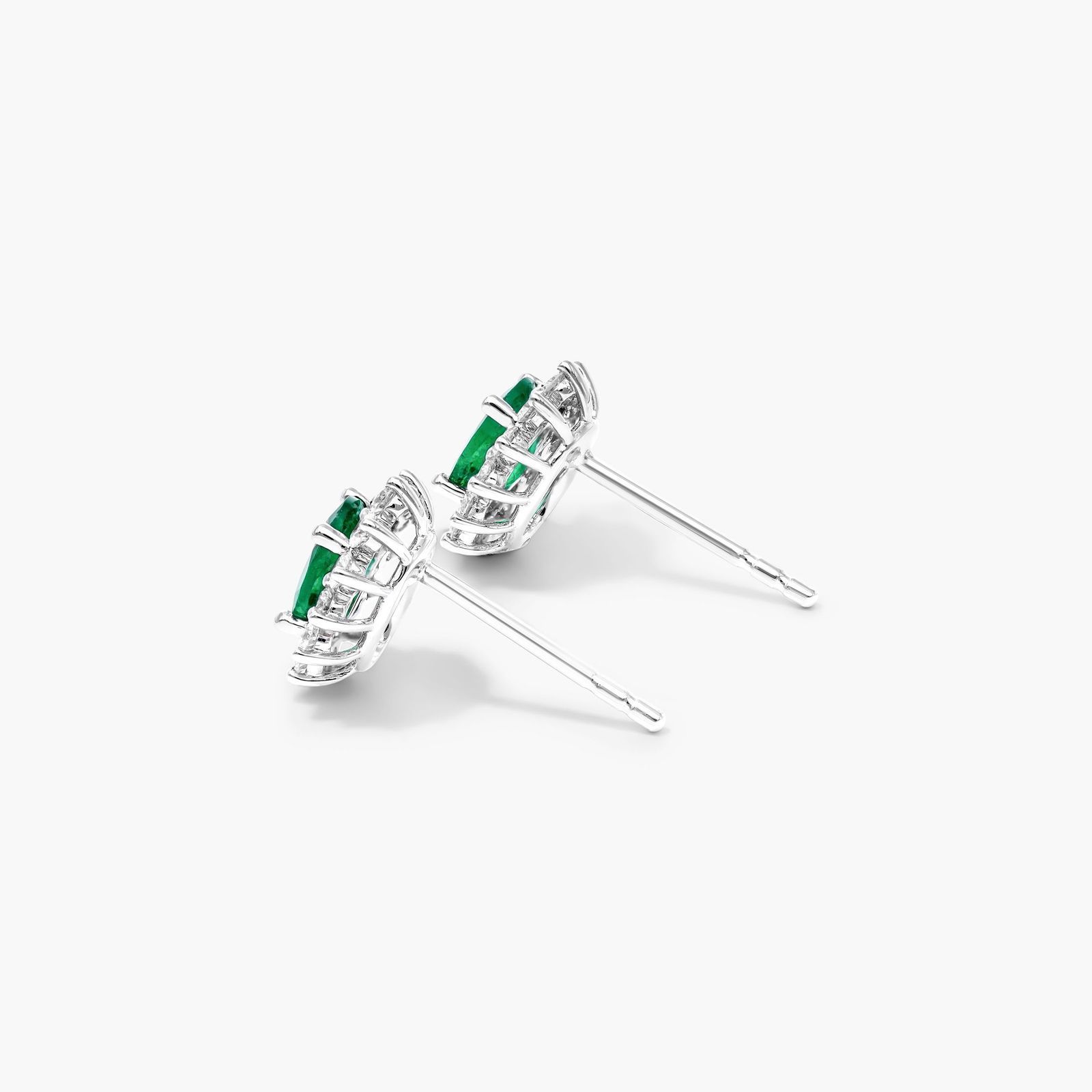 Oval Cut Emerald And Diamond Halo Earrings In 18K White Gold