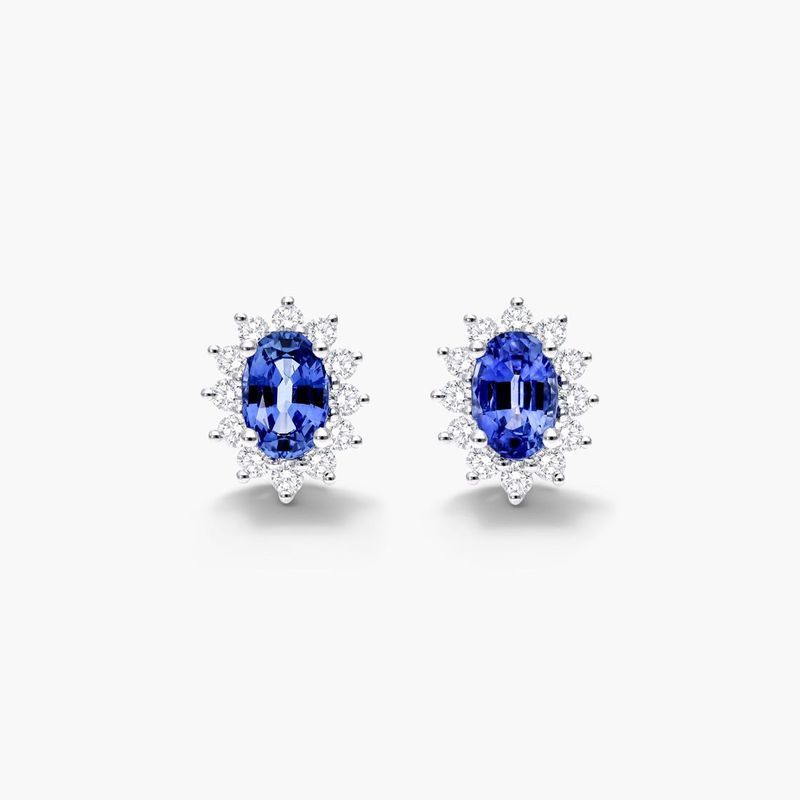 Oval Cut Sapphire And Diamond Halo Earrings In 18K White Gold