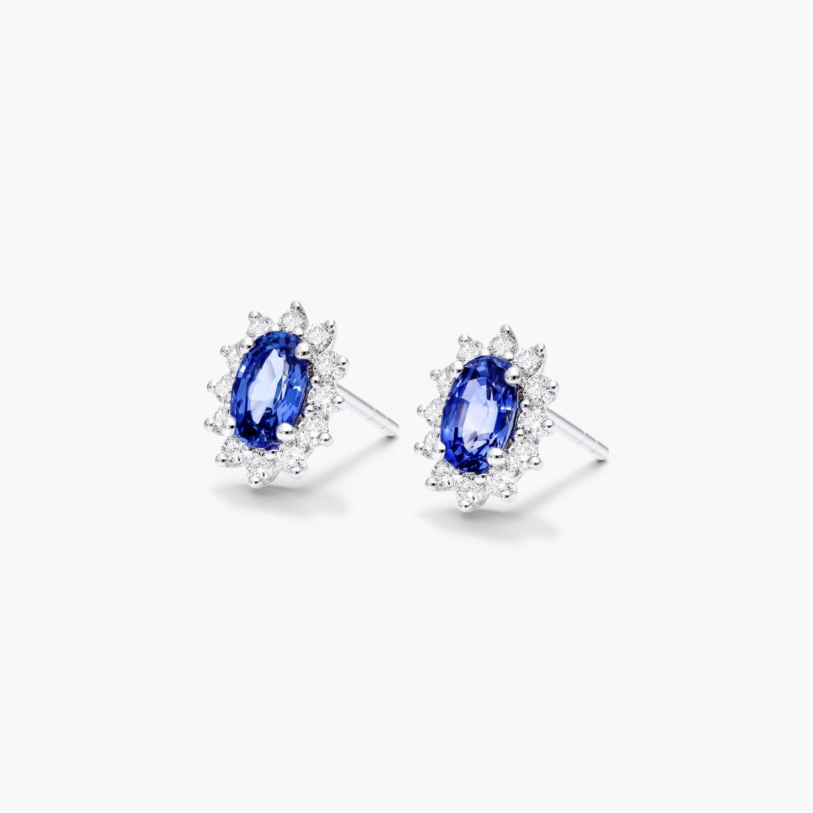 Oval Cut Sapphire And Diamond Halo Earrings In 18K White Gold