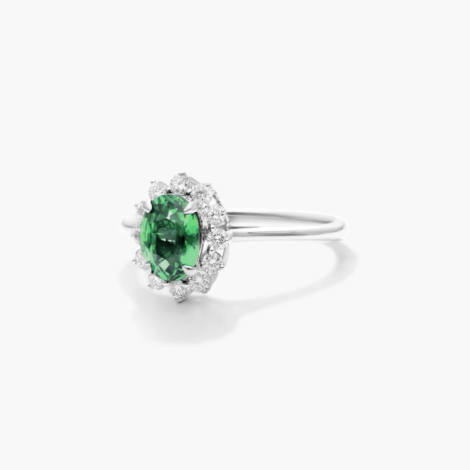 Oval Halo Emerald And Diamond Ring In 18K White Gold
