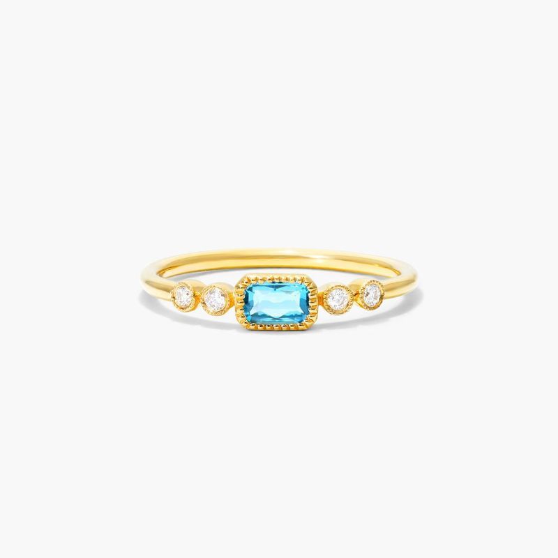 Dainty Blue Topaz Bezel Diamond Ring In 14K Yellow Gold by Brevani