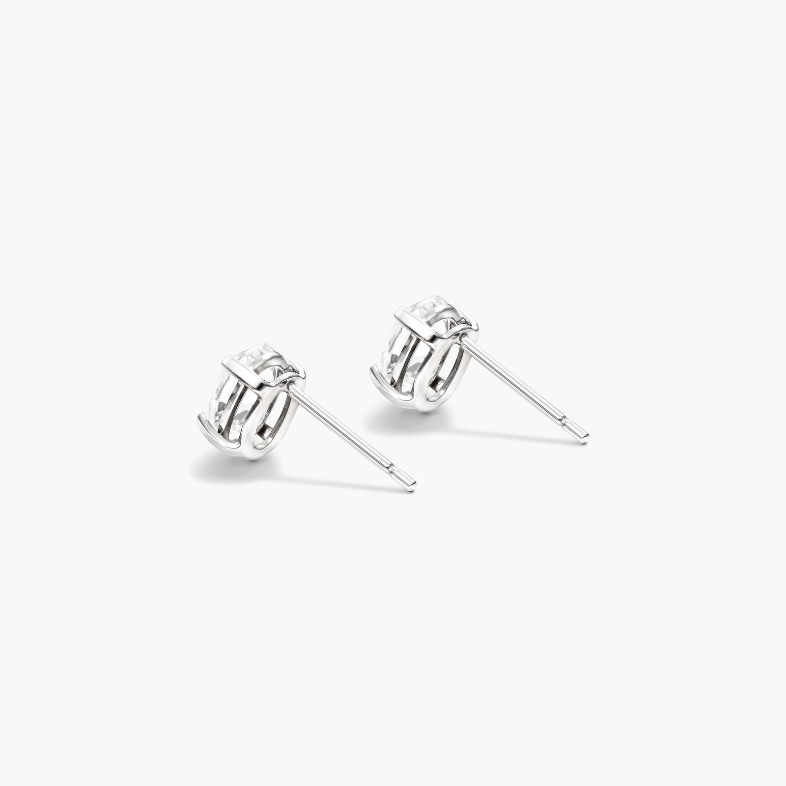 Oval Cut White Topaz Birthstone Earrings In 14K White Gold
