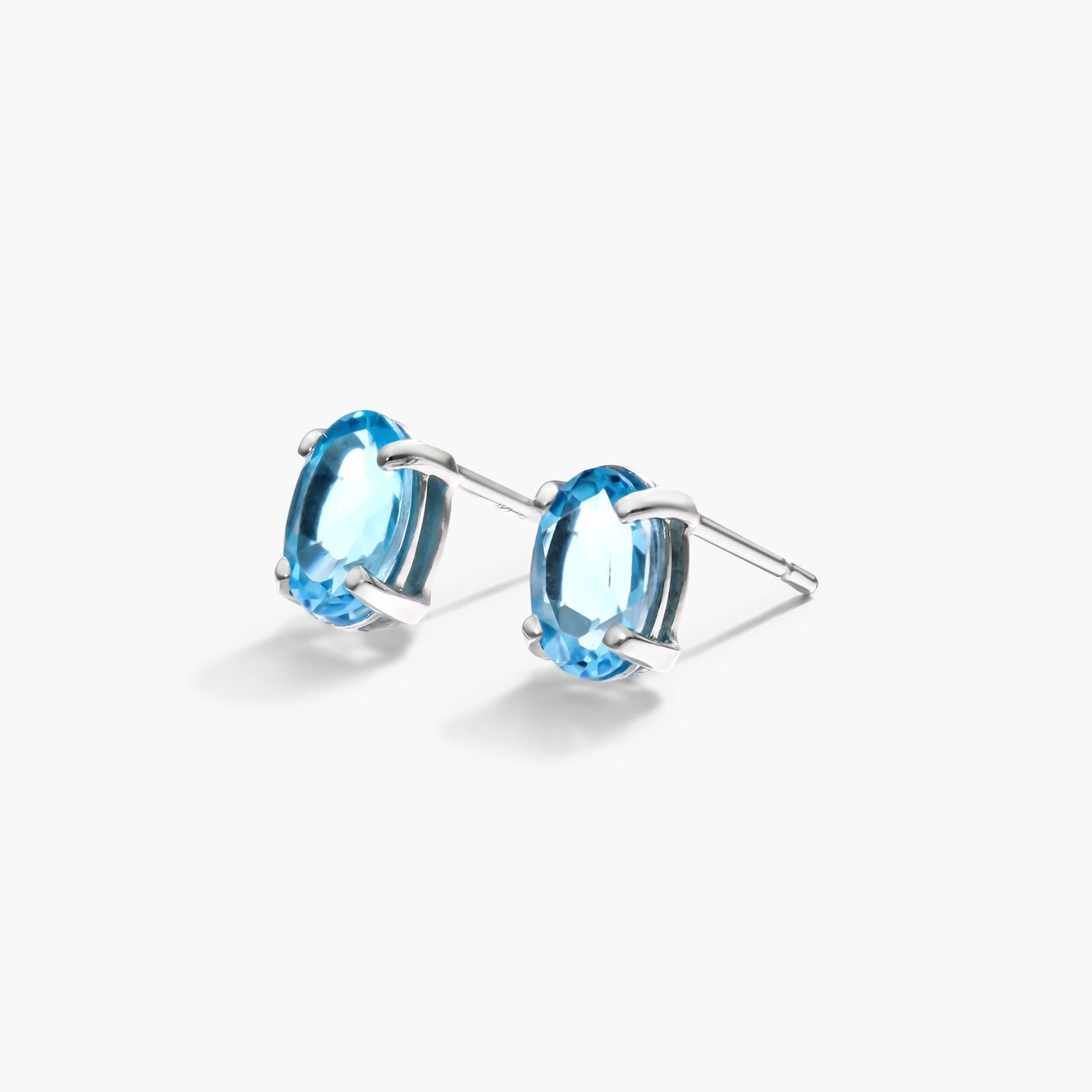 Oval Cut Blue Topaz Birthstone Earrings In 14K White Gold