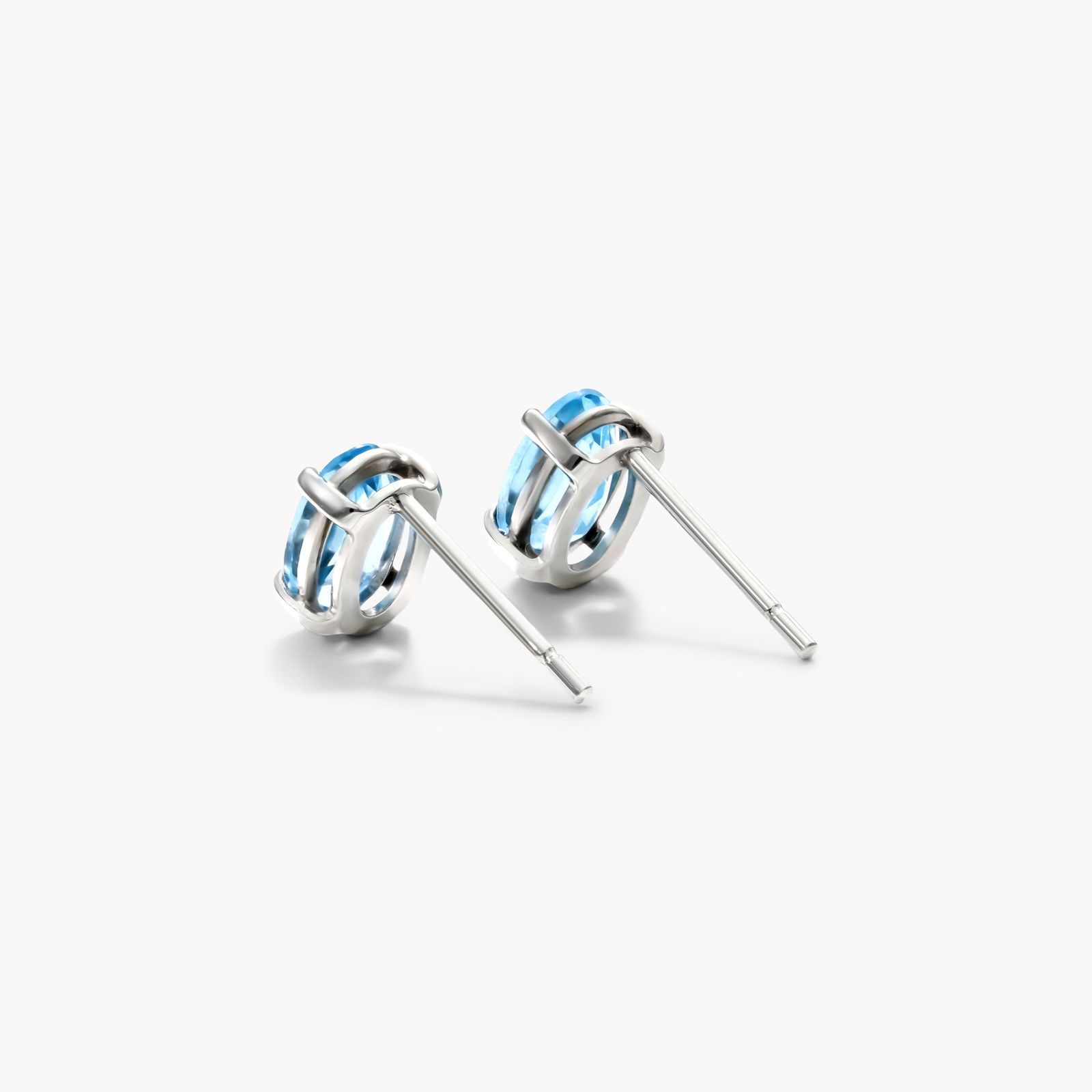 Oval Cut Blue Topaz Birthstone Earrings In 14K White Gold