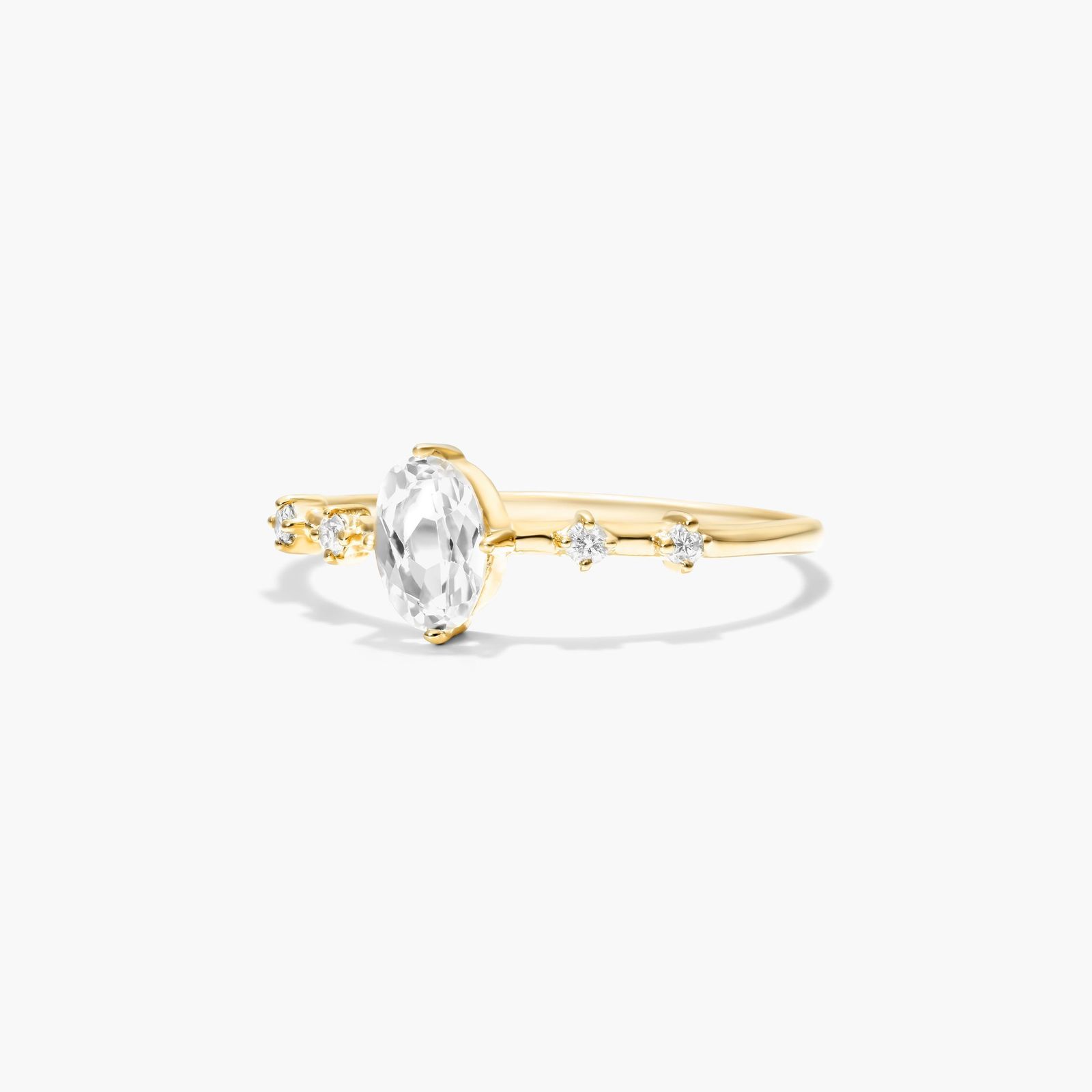 Oval White Topaz And Diamond Birthstone Ring In 14K Yellow Gold