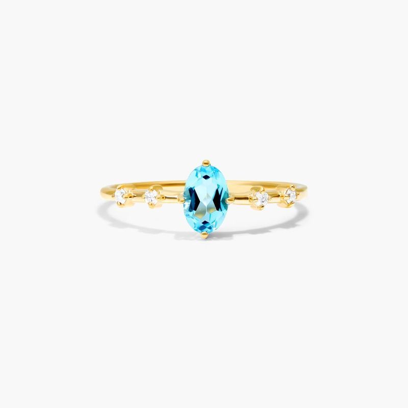 Oval Blue Topaz And Diamond Birthstone Ring In 14K Yellow Gold