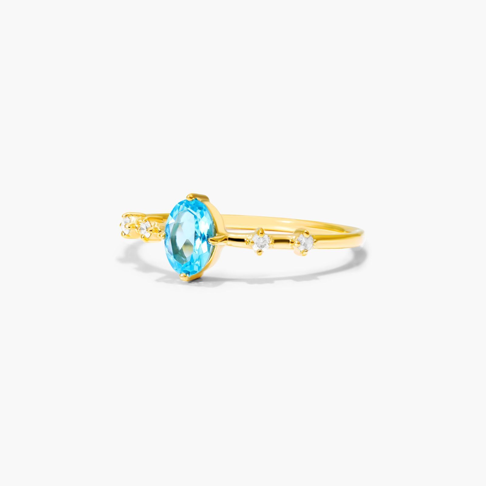 Oval Blue Topaz And Diamond Birthstone Ring In 14K Yellow Gold