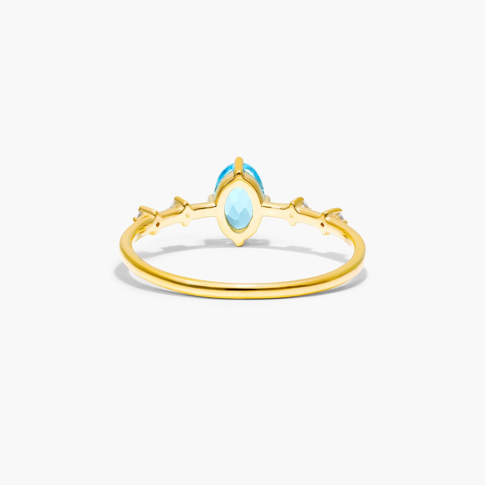 Oval Blue Topaz And Diamond Birthstone Ring In 14K Yellow Gold